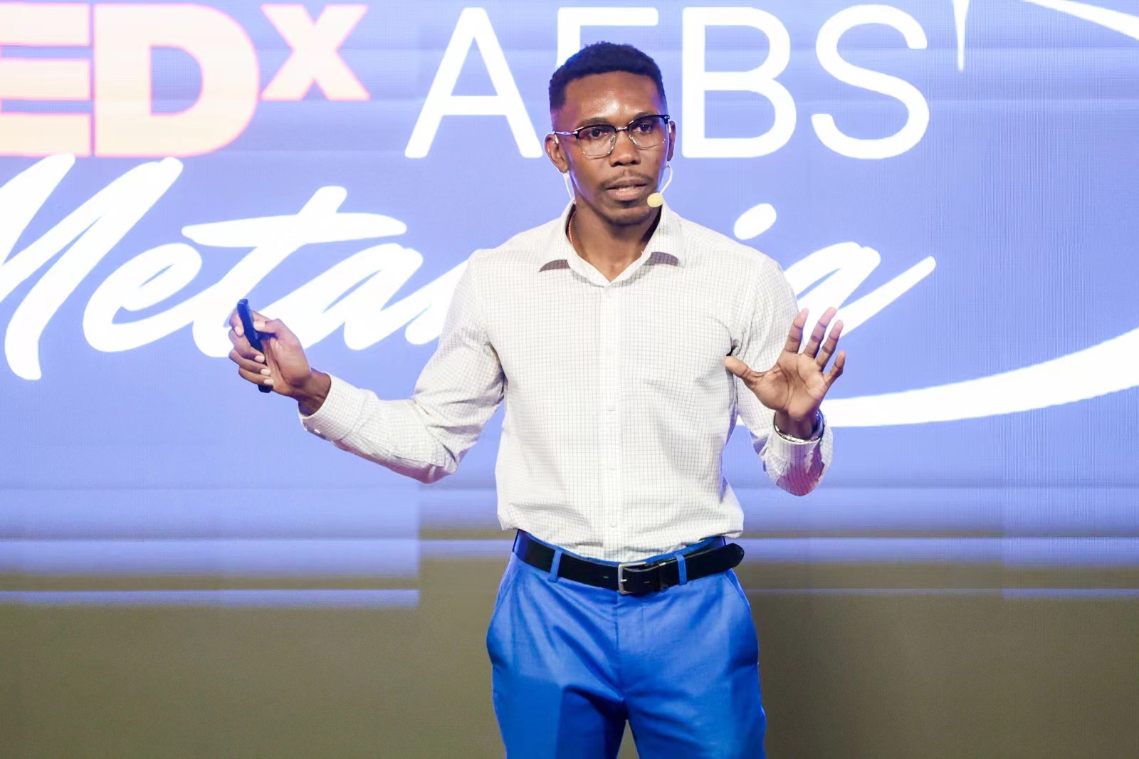 Deano Delpleash speaking on the TEDx AEBS Metanoia stage